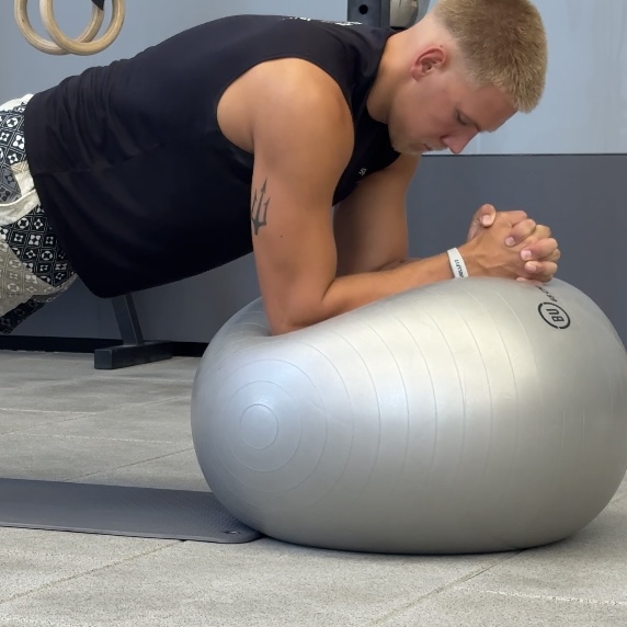 Swimmer holding a stability-ball plank