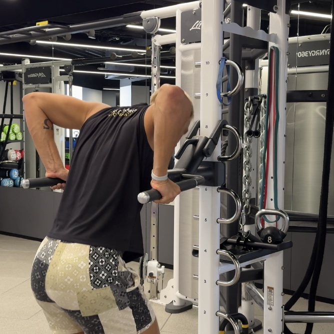 Swimmer performing a bent-over row on a cable machine